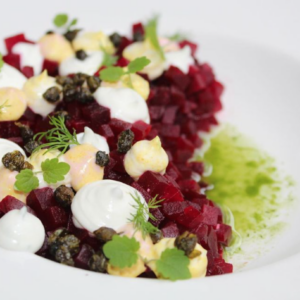 Beet tartare with whipped goats cheese, popped capers and dill oil.