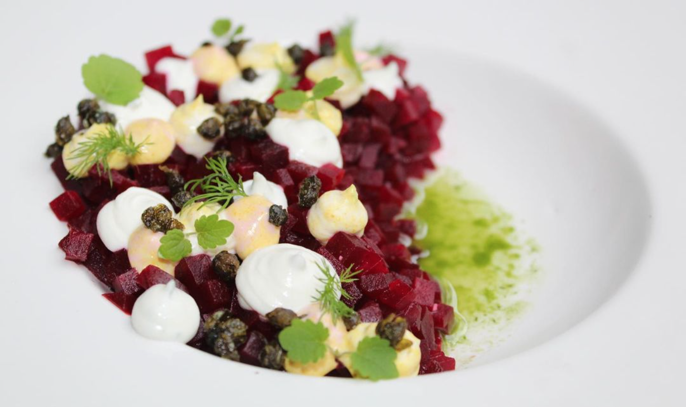 Beet tartare with whipped goats cheese, popped capers and dill oil.